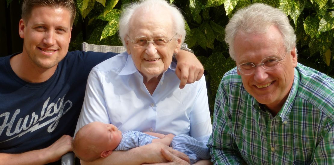 Four generations of men in one family smiling at the camera - Tisser Law Group Estate and Gift Tax Planning